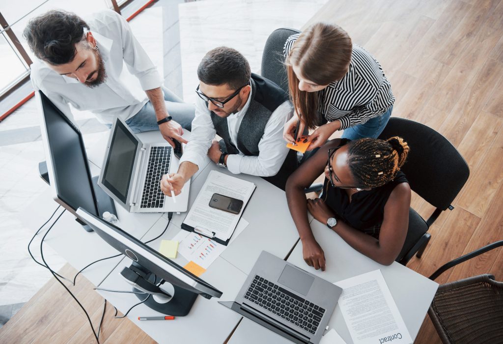 A group of multinational busy people working in the office. Height view